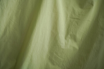 Background made of light green fabric.