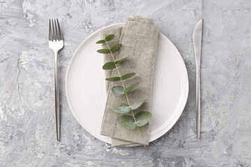 Elegant setting with silver cutlery on grey textured table, flat lay
