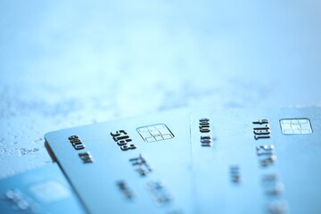 Plastic credit cards on table, closeup view. Space for text