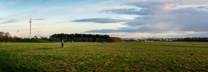Large panorama of Phoenix Park in Dublin. Cranes in background.