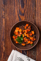 Comfort food with roasted sweet potatoes, lentils and herbs, delicious lunch or dinner, high angle view