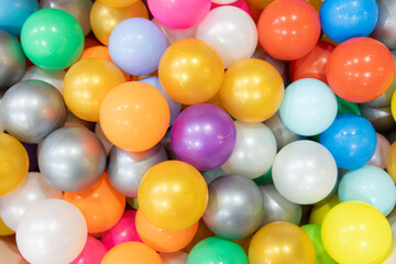 A bunch of colorful plastic balls are piled up