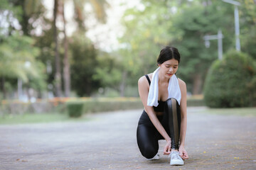 Young Asian woman running hard on the street at the park after daily exercise. Jogging to keep fit...