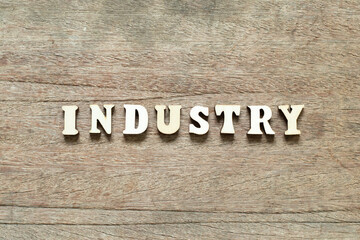 Alphabet letter block in word industry on wood background