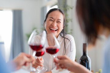 good old friend visit home asian mature woman friend talking standing in kitchen positive conversation good relation friendship reunion home visit casual relax hand hold wine glass goodvibe at home