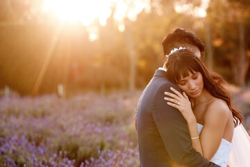 Wedding, sunset and couple hug in garden with love, celebration and commitment with gratitude or...