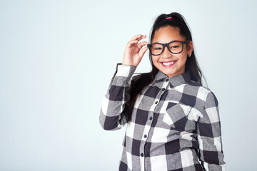 Studio, eye care and portrait of kid with glasses for optometry, wellness and healthy eyesight. Girl, mockup and prescription spectacles of child with pride, smile and confidence on white background