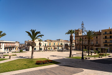 Main square known as Piazza Unità d'Italia in Ispica, a charming town in south-eastern Sicily, under an intensely blue sky