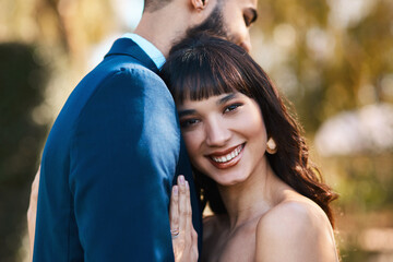 Fototapeta premium Couple, portrait and hug on ceremony at wedding, happy and commitment for marriage or relationship. People, embrace and smile in outdoor event, partnership and celebration of love or forever bonding