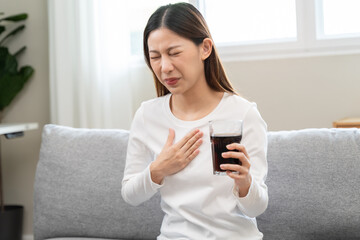 Acid reflux disease, suffer asian young woman have symptom gastroesophageal, esophageal, stomach ache and heartburn pain hand on chest from digestion problem after eat food, Healthcare medical concept