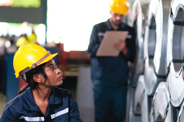 Fototapeta premium Portrait of a heavy equipment female engineer from a huge industry who came to inspect the metal sheet factory's machinery.