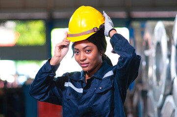 Portrait of a heavy equipment female engineer from a huge industry who came to inspect the metal sheet factory's machinery.