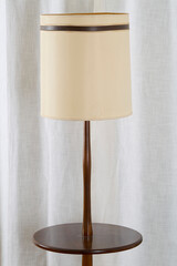Vintage 1960s table floor lamp. Mid-century modern walnut furniture. Home interior photograph.