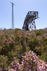 Metal structure tower with concrete base from coal mine cable cart industrial abandoned cableway on...
