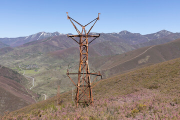 Abandoned metal tower structure in mountain landscape of Asturias Spain on a bright  day