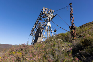 Abandoned industrial coal mining steel structure tower from cableway with cable in Tormaleo...