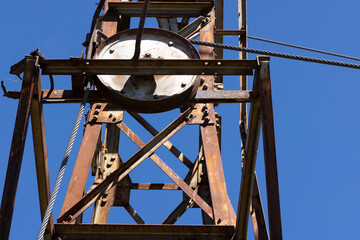 Detailed closeup of metal wheel with cable abandoned equipment for mining.