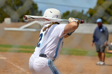 Young Female fastpitch softball player playing club sports.