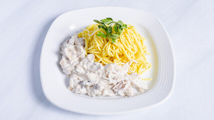 Creamy chicken with spaghetti on plate