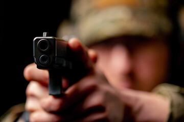 close-up at a professional shooting range a military trainer in ammunition takes aim with a pistol