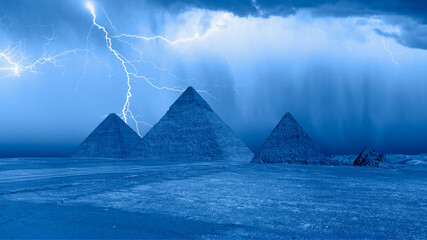 Pyramid complex of Giza at night in a thunderstorm and lightning. Giza, Cairo, Egypt