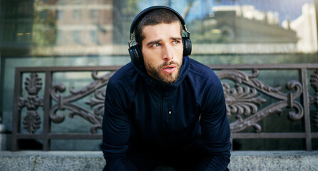 Headphones, man or athlete in city thinking of workout, training or outdoor exercise with radio...