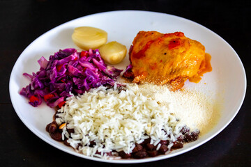 Traditional weekly Brazilian lunch, beans, rice, meat, vegetables and cassava flour