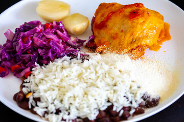 Traditional weekly Brazilian lunch, beans, rice, meat, vegetables and cassava flour