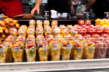 Fruit Salad arranged in plastic cups on a market. Cut and ready fruit ready to sell in market....