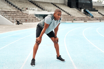 Tired, black man or athlete breathing after running on track for exercise, fitness and cardio in...