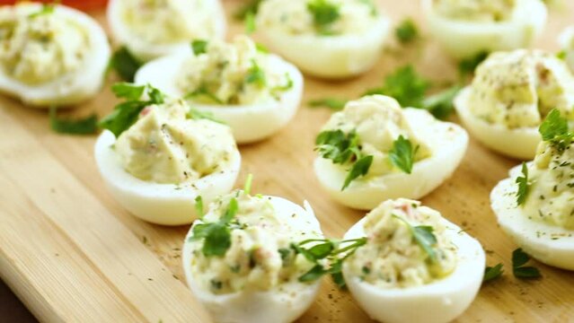 stuffed eggs, deviled eggs on a wooden table