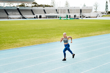 Athlete, woman and running on track for fitness, exercise and training, speed and endurance for marathon race. Active, female person and sport with energy, power and activity for competition