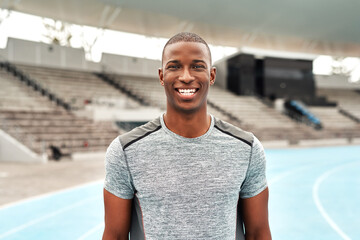 Confident, black man or athlete portrait on stadium track for fitness, running and training for...