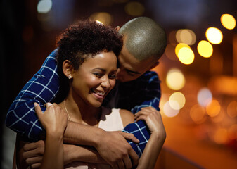 Happy couple, hug and city travel at night or downtown date for relationship romance, bokeh or...