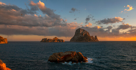 Panoramic view of Es Vedra and Es Vedranell islands with golden light and sunset clouds, Sant Josep de Sa Talaia, Ibiza, Balearic Islands, Spain