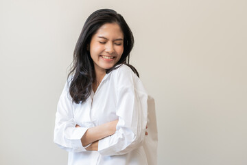 Smile positive, happy asian young woman wearing casual shirt, portrait of beautiful female with black long hair feeling prond, standing crossed arms looking at camera, isolated on white background.