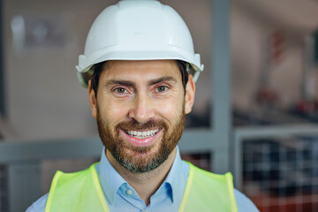 Construction worker, engineer. portrait of happy man in vest and helmet for safety smile