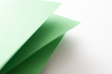 Green and white 3d colored paper background, close up