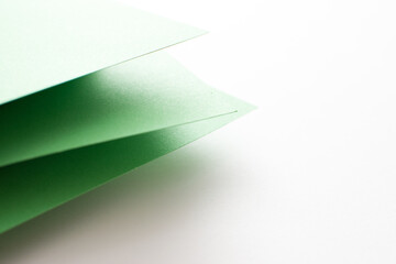 Green and white 3d abstract colored paper background, close up