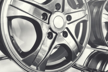 Close-up of alloy wheels for passenger cars on a store stand.