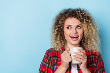 Photo of crazy funky surprised lady hold tea cup look empty space wear plaid shirt isolated blue...