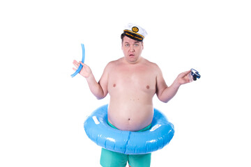 Vacations and holidays. Funny fat man with an inflatable blue circle posing in the studio on a white background. Fun and joy.