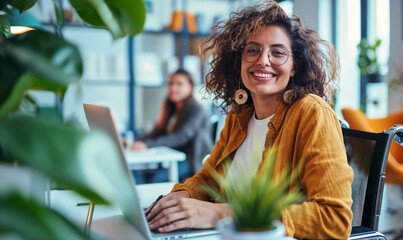 Beautiful woman in a wheelchair at work in a modern office. Happy Latina/Hispanic disabled handicapped employee, accessibility, diversity and  inclusion for all satff and  workers.