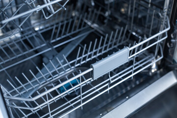 Crop of drawer in empty dishwasher