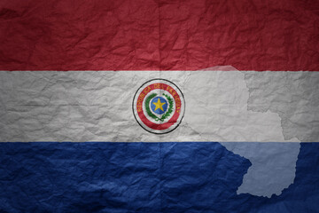 Naklejka premium big national flag and map of paraguay on a grunge old paper texture background