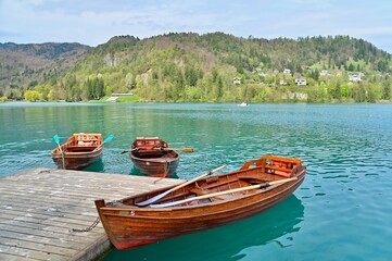 Traditional Wooden Boats at Pier of Lake Bled, Alpine Lake in Slovenia