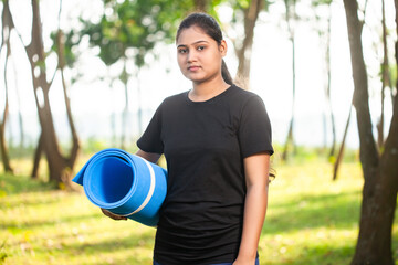 fitness women holding a exercise mat