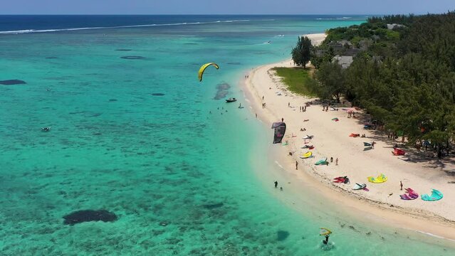 Kitesurfers, windsurfers on the Le Morne beach, famous aquatic sports spot in Mauritius island. Kite surfing in the clear waters of the Indian Ocean in Le Morne beach, Mauritius.