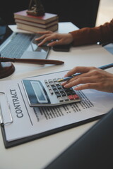 American woman lawyer or businesswoman African working with laptop, searching, analyzing data, reading contract documents work with law books hammer of justice Consulting lawyer concept.