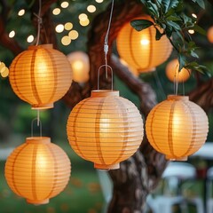 Amber paper lanterns adorn the tree, creating a festive holiday decoration